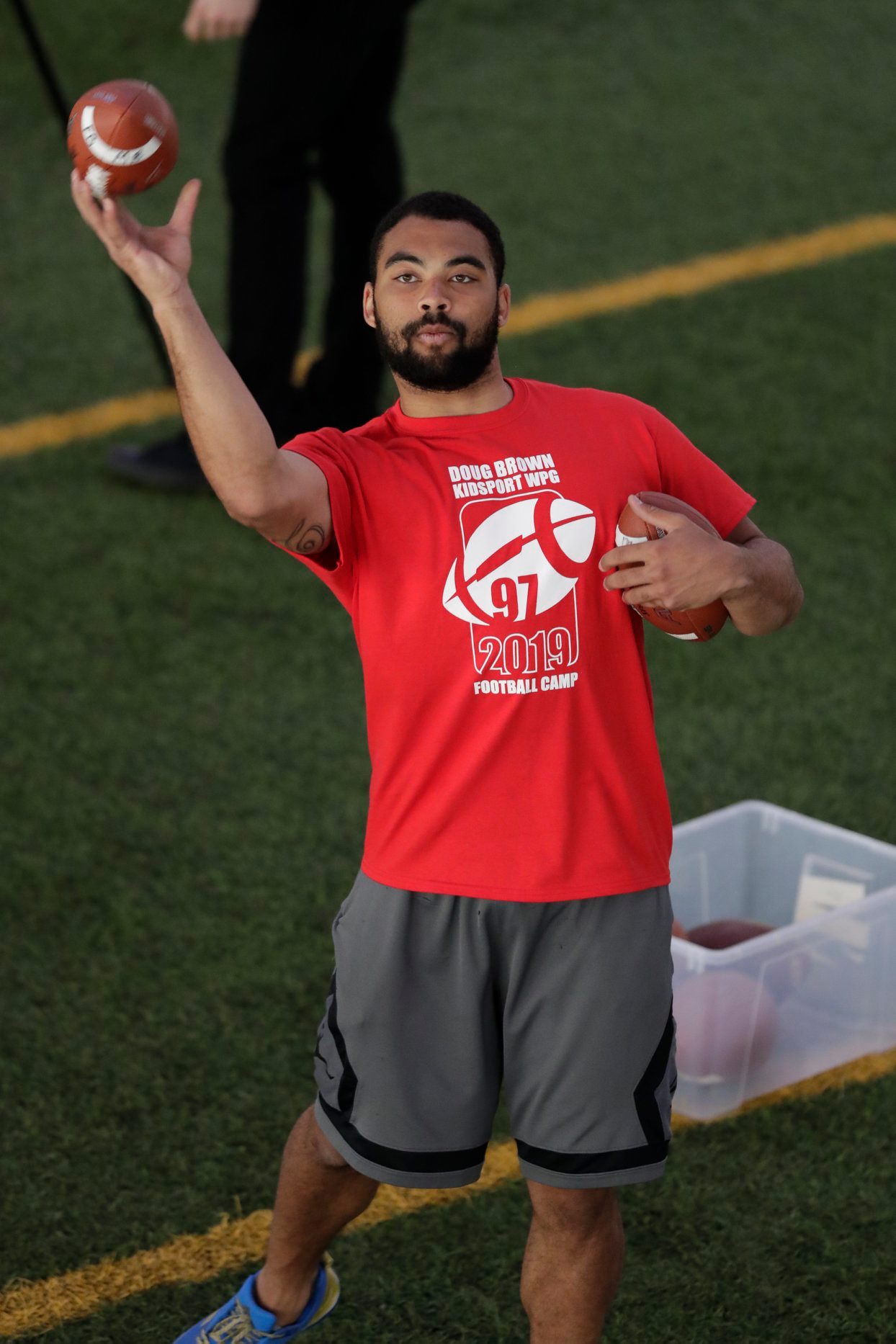 Nic Demski throws a football at the annual Doug Brown KidSport Football Camp