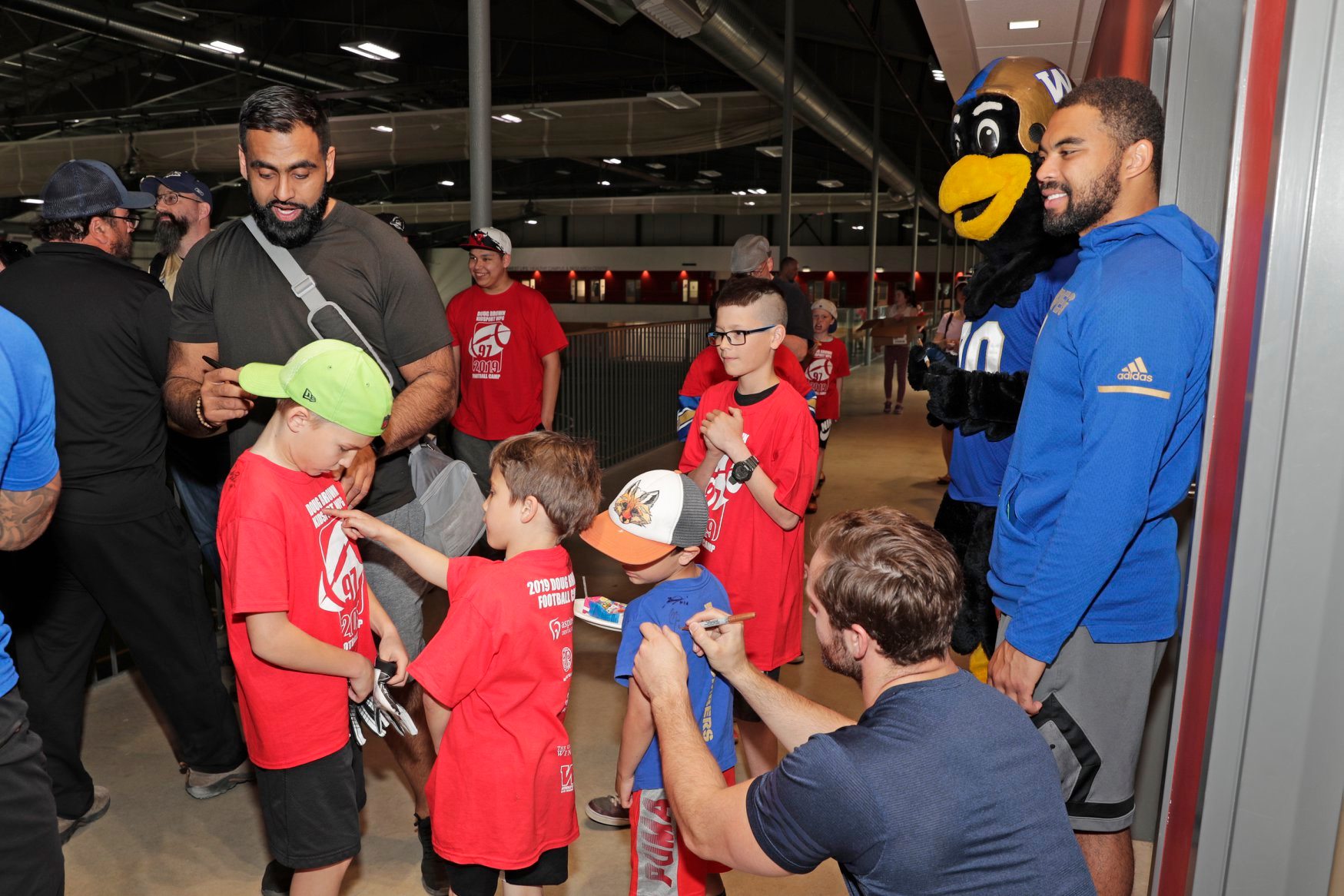 Nic Demski with Blue Bombers mascot Boomer at the 2-19 Doug Brown Football Camp